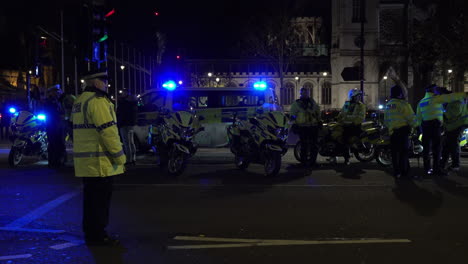 Metropolitan-police-officers-stand-by-motorbikes-on-a-road-junction-on-Parliament-Square-during-a-rod-traffic-operation-at-night