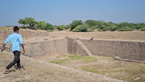 Dholavira-Archeology-Heritage-Site,-a-5000-year-old-step-well-being-viewed-by-people