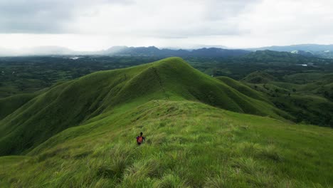 Person-walk-on-magnificent-green-scenery-trail-at-Mount-Labawan,-Philippines