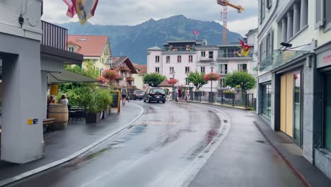 Interlaken-Switzerland-Immersive-Travel-Tourism-Mountainside-Valley-Resort-City,-Europe,-Walking,-Rainy-Day,-4K-|-Looking-Around,-Shaky,-Water,-River,-Lake,-Restaurant,-Tourist,-Group,-Alley,-View