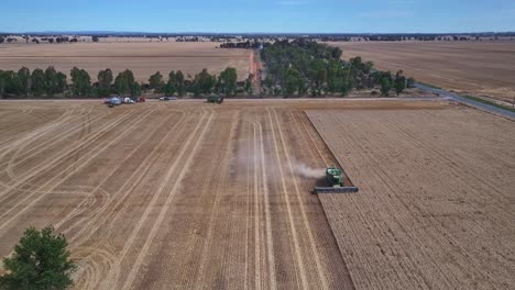 Wide-aerial-view-of-a-harvester-working-in-a-wheat-field-near-Yarrawonga-with-farm-equipment-beyond