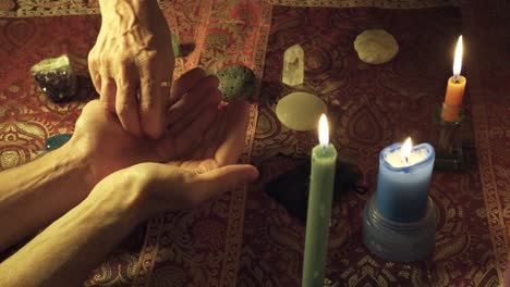 Close-up-shot-of-a-witch-handing-a-magical-healing-stone-to-another-person-to-heal-the-mind-in-a-mystical-ritual