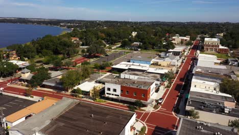 Drone-orbits-around-historic-downtown-Clermont-with-scenic-view-of-lake-in-background