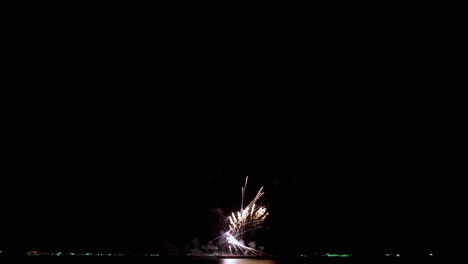 Systematic-launching-of-fireworks-from-low-to-high-altitudes-reveals-a-climax-to-an-extraordinary-display-of-colored-sparks-and-flames-with-bokeh-lights-in-the-night-sky