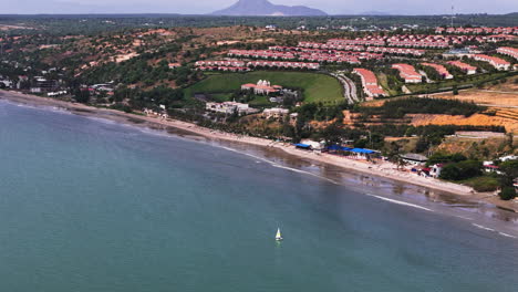 Aerial-approaching-shot-of-Sailing-boat-in-front-of-Centara-Resort-in-Mui-Ne-at-sunny-day