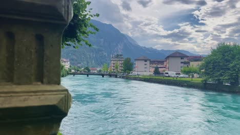 Interlaken-Switzerland-Immersive-Travel-Tourism-Mountainside-Valley-Resort-City,-Europe,-Walking,-Rainy-Day,-4K-|-Looking-Around,-Shaky,-Water,-River,-Lake,-Restaurant,-Hotel,-Car,-Flowing,-Bridge