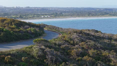 Car-driving-along-scenic-coastal-road-in-Western-Australia-at-sunset