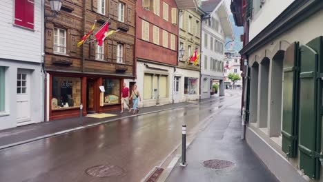 Interlaken-Switzerland-Immersive-Travel-Tourism-Mountainside-Valley-Resort-City,-Europe,-Walking,-Rainy-Day,-4K-|-Looking-Around,-Shaky,-Water,-River,-Lake,-Restaurant,-Couple,-Holding-Hand,-Alley