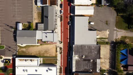 Drone-top-down-bird's-eye-view-of-historic-main-street-road-and-buildings-at-midday