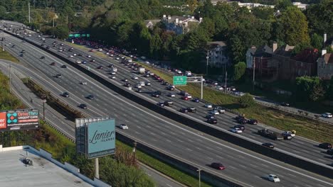 Aerial-shot-of-full-exit-lane-on-freeway-in-Atlanta-City-during-sunny-day,-Georgia