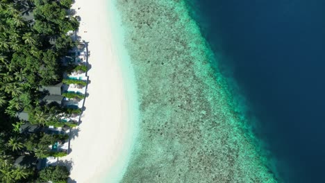 Tropical-Island-Paradise---Malahini-Kuda-Bandos,-Maldives:-Aerial-drone-full-island-beach-and-reef-from-above