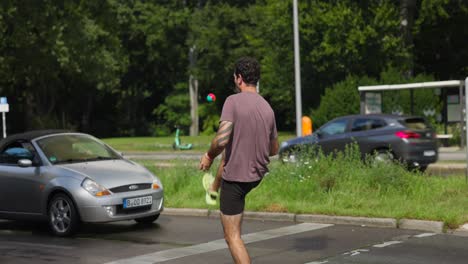Man-juggling-in-front-of-cars-on-a-zebra-crossing