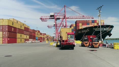 Haulage-truck-carrying-heavy-container-departing-from-Port-of-Montreal-container-ship-terminal