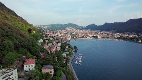 Aerial-toward-villas-in-the-mountainside-town-of-Como,-Italy