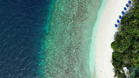 Tropical-Island-Paradise---Malahini-Kuda-Bandos,-Maldives:-Aerial-drone-reef-flyover