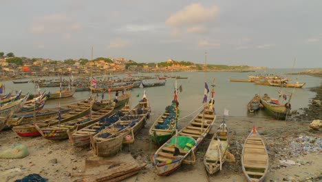 Fishing-boats-on-beach-by-harbor-at-Cape-Coast-in-Ghana-at-golden-hour