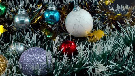 Christmas-decoration,-colorful-hanging-ornaments,-blue-green-white-gold-colors,-new-year-decorated,-shiny-lights,-cinematic-close-up-pan-right-4K-video