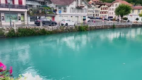 Interlaken-Switzerland-Immersive-Travel-Tourism-Mountainside-Valley-Resort-City,-Europe,-Walking,-Rainy-Day,-4K-|-Looking-Around,-Shaky,-Water,-River,-Lake,-Restaurant,-Cafe,-Flowers,-Couple,-Biker