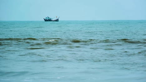 Fishing-trawler-at-sea-seen-from-the-beach