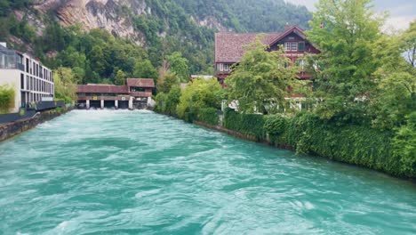 Interlaken-Switzerland-Immersive-Travel-Tourism-Mountainside-Valley-Resort-City,-Europe,-Walking,-Rainy-Day,-4K-|-Looking-Around,-Shaky,-Water,-River,-Lake,-Restaurant,-Tourists,-Bench,-Flowing-Water