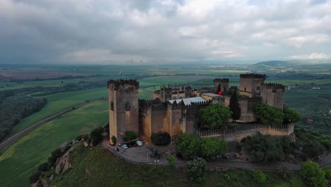 Splendid-drone-view-of-Almodovar-del-Rio-Castle-on-cloudy-day,-Cordoba