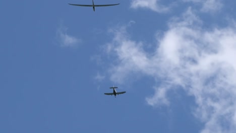 -Motor-plane-and-glider-plane-spotted-flying-in-the-sky-on-clear-bright-day