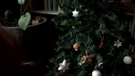 Woman-decorating-a-Christmas-tree-with-cute-felt-mushroom-decoration-4K
