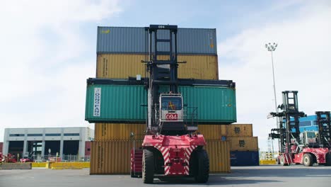 Crane-truck-lifting-and-stacking-heavy-container-in-Port-of-Montreal-loading-terminal
