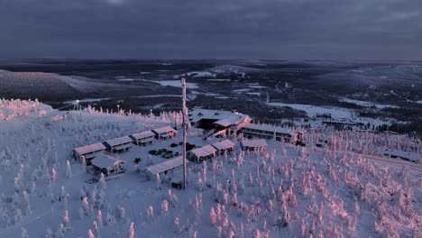 Aerial-view-around-Hotel-Iso-Syöte,-dramatic-winter-sunset-in-Syote,-Finland