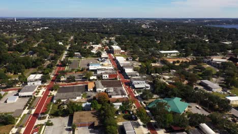 Panoramic-aerial-orbit-above-historic-downtown-Clermont-Florida-with-panning-view-to-lake