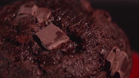 Extreme-close-up-macro-shot-of-a-Chocolate-Chunk-ship-muffin-on-red-plate