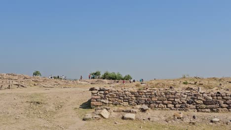 Dholavira-Archeology-Heritage-Site,-people-with-their-families-looking-at-the-5,000-year-old-archeology-site