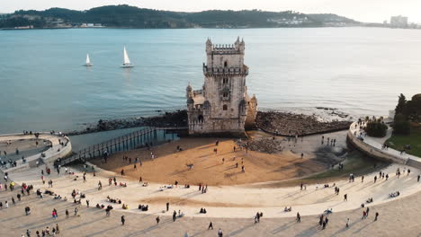 Aerial-view-showcasing-the-scenic-beauty-of-Torre-de-Belém,-Portugal,-an-iconic-monument