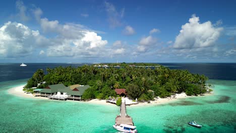 Tropical-Island-Paradise---Malahini-Kuda-Bandos,-Maldives:-Aerial-drone-rise-up,-reveal-island-and-Bandos-sister-island-backdrop