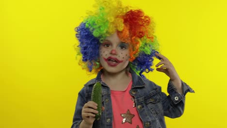 Little-child-girl-clown-in-colorful-wig-making-silly-faces,-singing,-smiling,-dancing.-Halloween