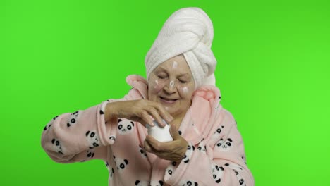 Elderly-grandmother-after-shower.-Old-woman-applying-moisturizing-cream-on-face