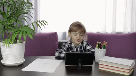 Girl-doing-online-homework-using-digital-tablet-computer.-Distance-education