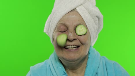 Elderly-grandmother-in-bathrobe-after-shower.-Old-woman-with-slices-of-cucumber