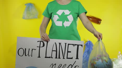 Unrecognizable-woman-with-protesting-poster-and-Earth-globe-in-plastic-package.-Ecology-pollution