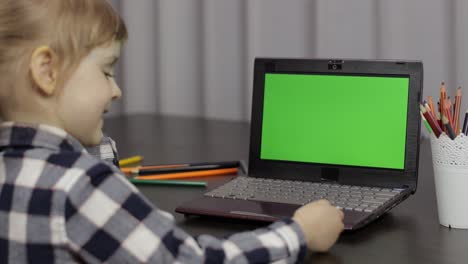 Children-distance-education-on-laptop-during-online-lesson-at-home.-Green-screen