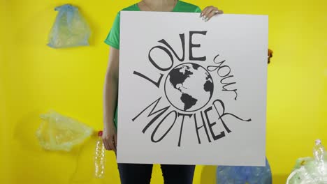 Unrecognizable-woman-holding-protesting-poster-Love-Your-Mother-Earth.-Environment-plastic-pollution
