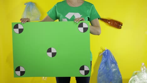 Unrecognizable-woman-holding-chroma-key-poster-with-tracking-points.-Environment-plastic-pollution