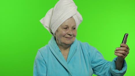Elderly-grandmother-after-shower.-Old-woman-making-selfies-using-mobile-phone