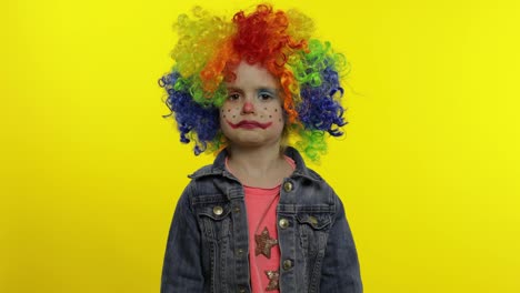 Little-child-girl-clown-in-colorful-wig-receives-money-income-in-banknotes-dollar-cash.-Smiling