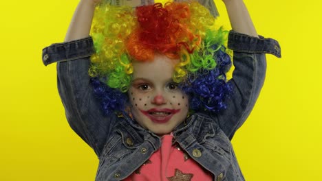 Little-child-girl-clown-in-wig-making-silly-faces,-having-fun-with-money-banknotes-dollar-cash