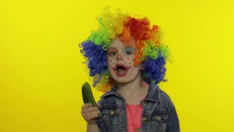 Little-child-girl-clown-in-rainbow-wig-making-silly-faces,-singing,-smiling,-dancing.-Halloween