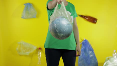 Unrecognizable-woman-with-Earth-globe-in-plastic-package.-Save-ecology.-Plastic-nature-pollution
