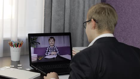 Man-teacher-making-video-call-on-laptop-with-little-pupil.-Distance-education