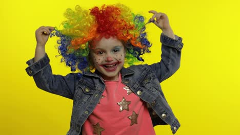 Little-Child-girl-clown-in-colorful-wig-making-silly-faces.-Fool-around,-smiling,-dancing.-Halloween