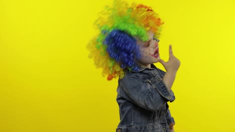 Little-Child-girl-clown-in-colorful-wig-making-silly-faces.-Having-fun,-smiling,-dancing.-Halloween